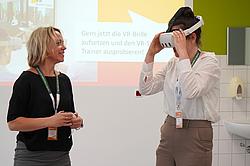 Die VR-Brille wird von einer jungen Frau getestet.