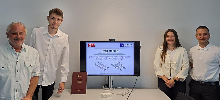 Angehende staatlich geprüfte Techniker der Eckert Akademie Regenstauf präsentieren die Ergebnisse ihrer praxisnahen Projektarbeiten vor einer Präsentationsfläche.