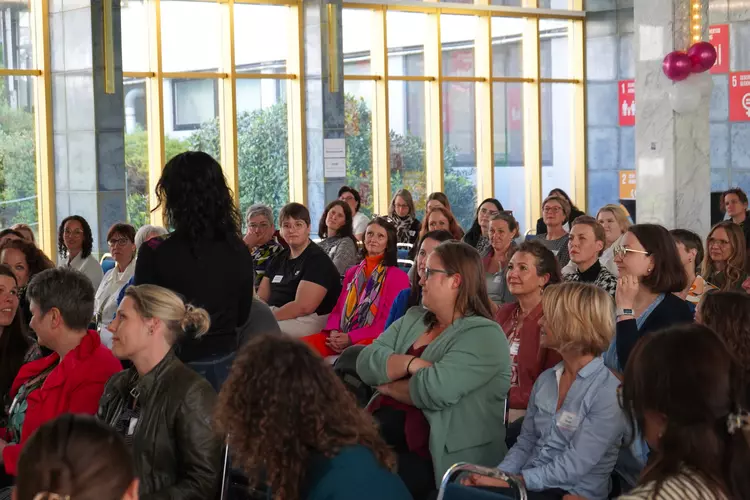 Teilnehmerinnen hören dem Vortrag gespannt zu.