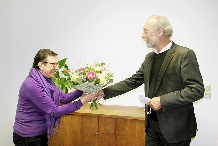 Gottfried Steger (Vorstand Bereiche Ausbildung, Weiterbildung, berufliche Rehabilitation) verabschiedet sich von der langjährigen Mitarbeiterin mit einem Strauß Blumen. Foto: Eckert Schulen